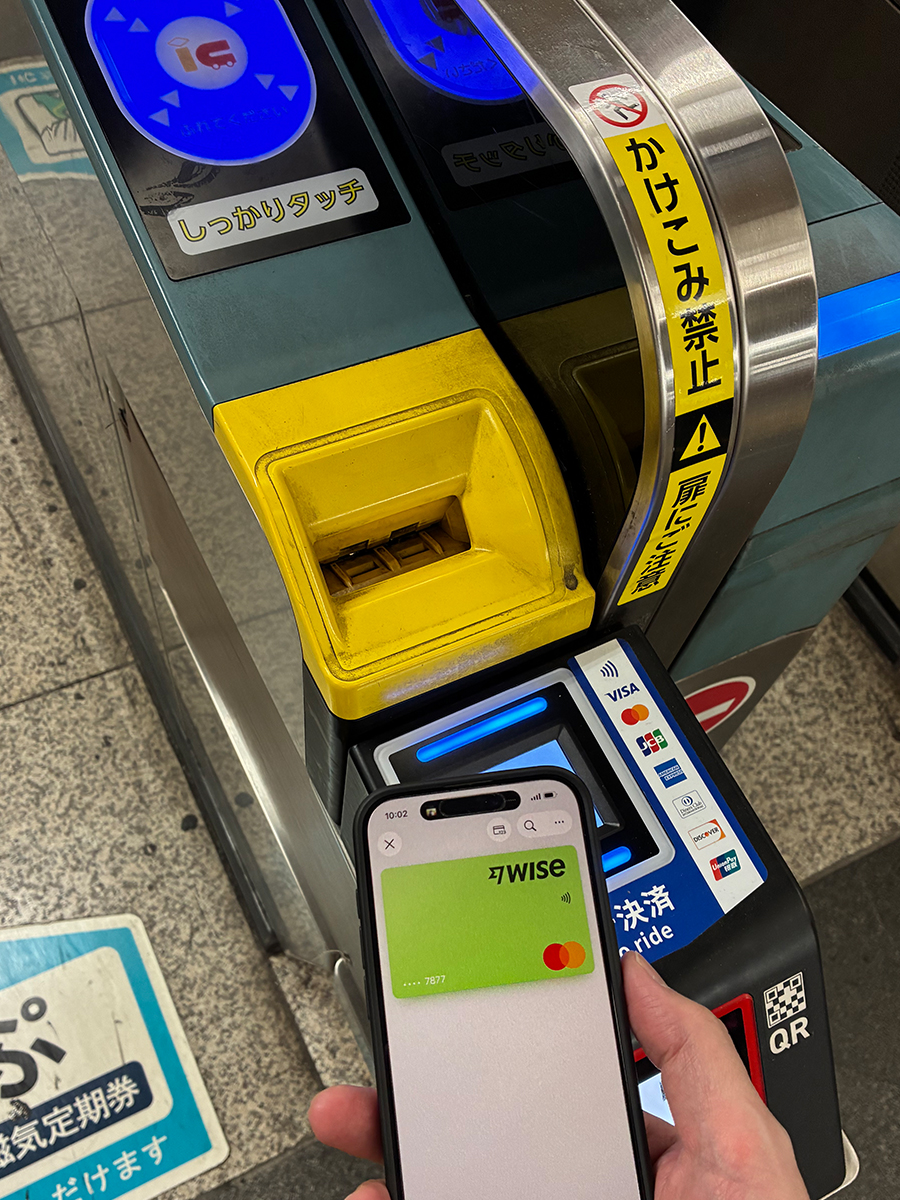 Alternate angle of iPhone Apple Wallet Wise card at Japan transit gate Tap to ride terminal